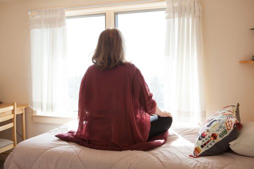 Image of as student meditating on a bed