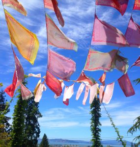 Image of prayers flags and the Berkeley skyline