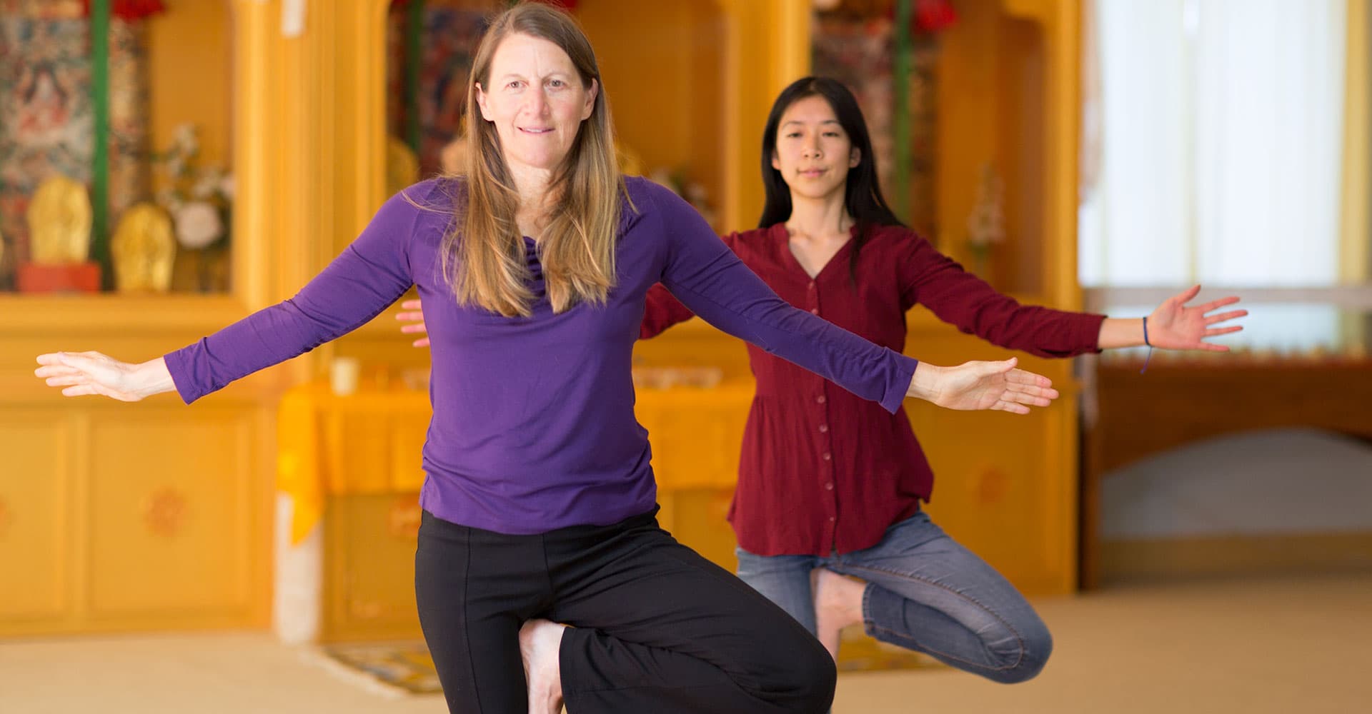 Image of a student and teacher performing Kum Nye